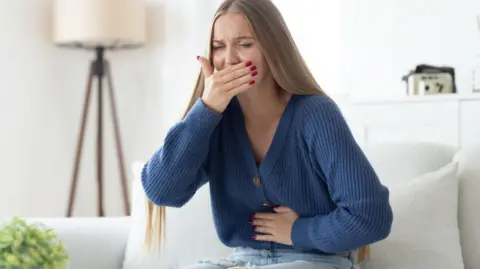 Getty Images Young woman feeling sick 