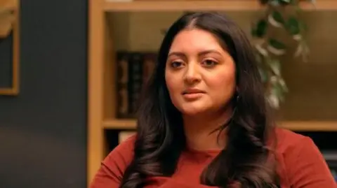 BBC / Twenty Twenty Productions Ltd Anjalee in therapy, long brown hair, against a blurred interior background