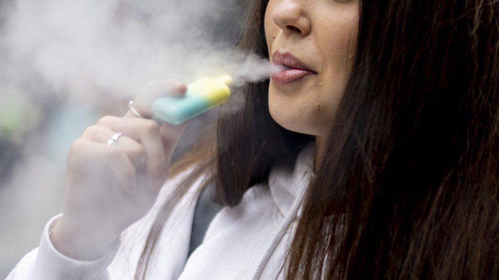 A young woman vaping