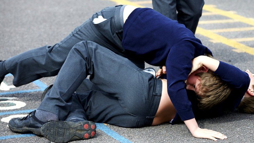 Two schoolboys fighting