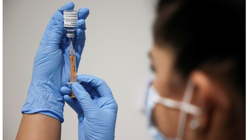 Woman holding vaccine