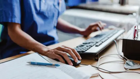 Getty Images A clinician accessing a patient's electronic notes 