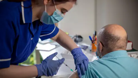 Getty Images Man receiving Covid vaccination