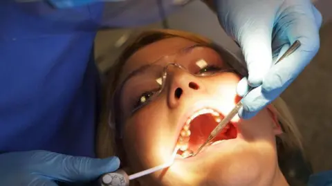 Getty Images Dentist and patient