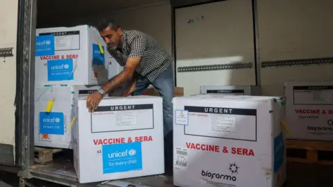 AFP A man unloads a shipment of boxes of polio vaccines provided with support from UNICEF to the Gaza Strip