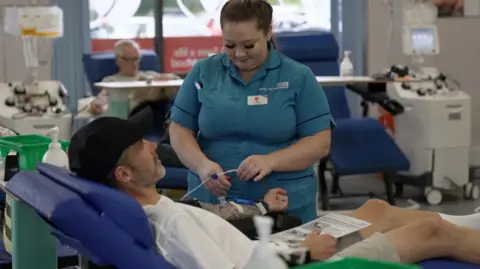 BBC Nurse with man who is donating blood