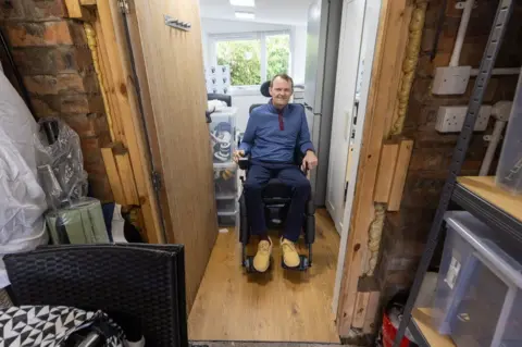 My Name'5 Doddie Foundation Scott Stewart sits in his wheelchair in his adapted home in Stirling