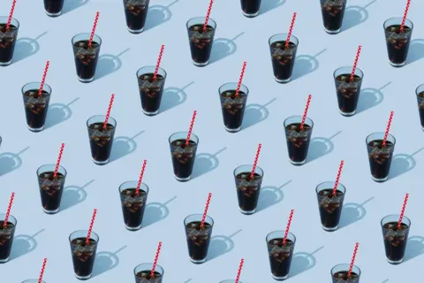 Getty Images Glasses of cola on a blue background