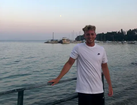 Kofi Bernson Kofi Bernson stands in front of a barrier on the seaside