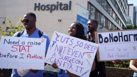 Getty Images NHS resident doctors protest outside St Thomas' Hospital in London