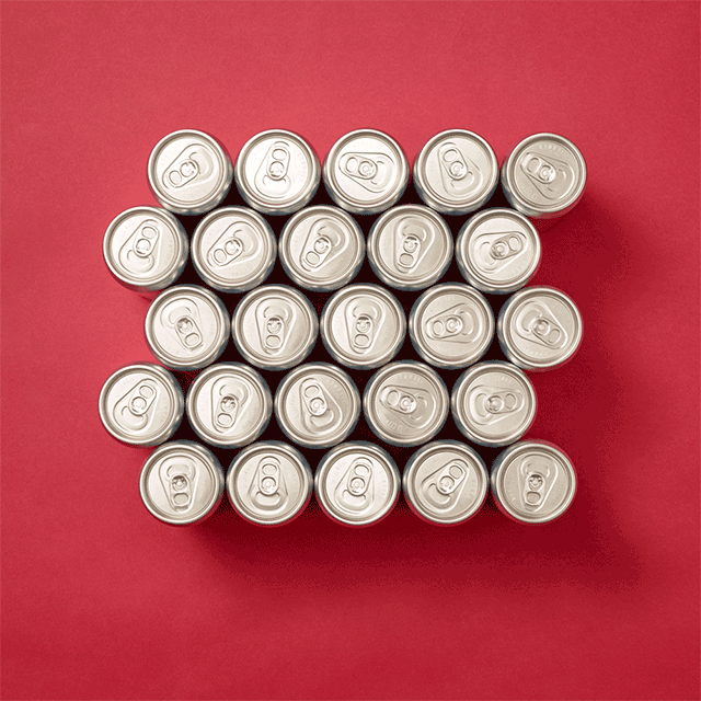 A top-down view of 20 silver aluminum cans in a hexagonal lattice, on a red background. 
