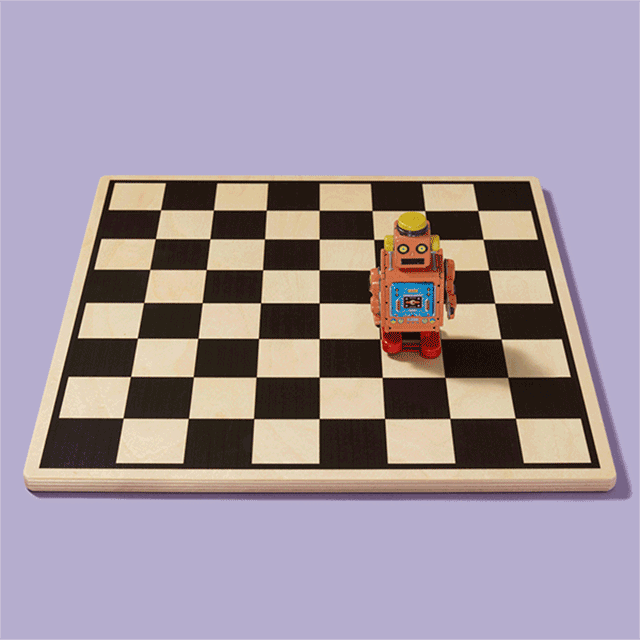 Wooden checkerboard on a light purple background, with a small, retro-style toy robot moving across it.