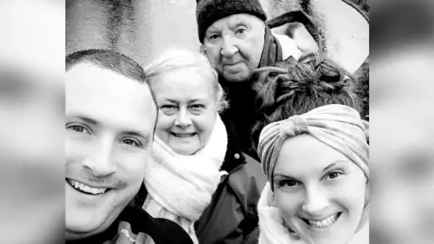 Charlotte Chapman-Hart Charlotte posing for a photograph with her Mum, Dad and brother, Tim by a river