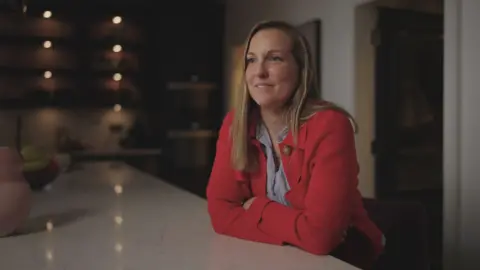 Charlotte Stirling-Reed wearing a red blazer