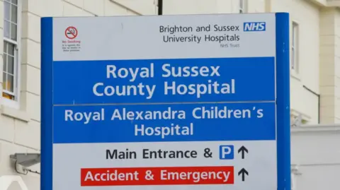 PA Media A sign outside the Royal Sussex County Hospital in Brighton.
