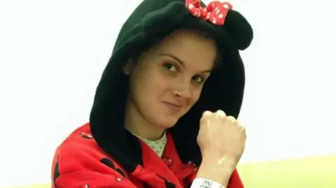 Charlotte Chapman-Hart Charlotte dressed in a mini mouse dressing gown in hospital ready to have brain surgery to remove part of her skull. 