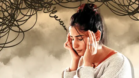 BBC Woman with hands on her head looking stressed