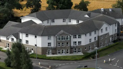 An exterior shot of a large modern care home