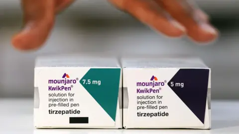 EPA A close up of two boxes of the drug Mounjaro with different doses. 