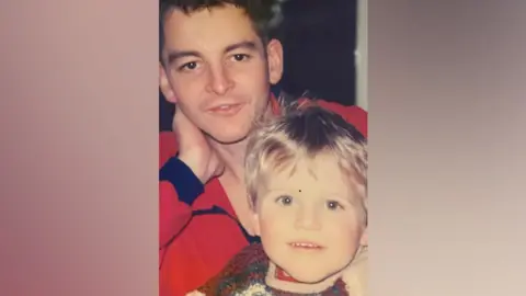 May-Davis family An old family photograph of Fred resting his head on his hand with a young Jack in his lap