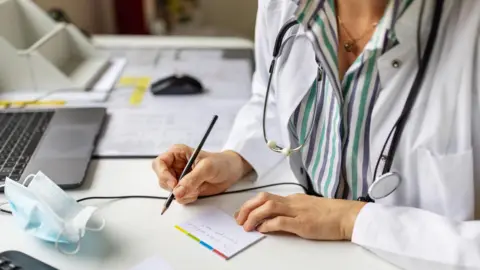 getty stock image of woman writing prescription