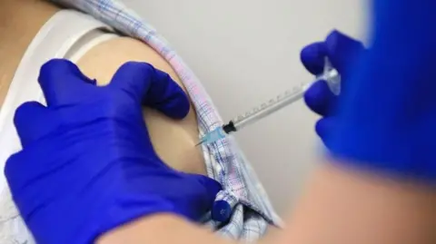 Getty Images Person getting Covid vaccination