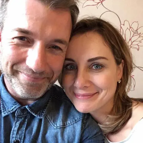 Hutchinson family Mark and Arlene Hutchinson smiling at camera.