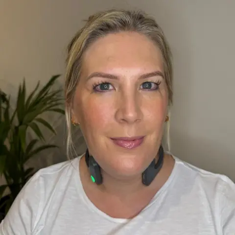 @lucylambertco Lucy Lambert wearing stimulation device on her neck