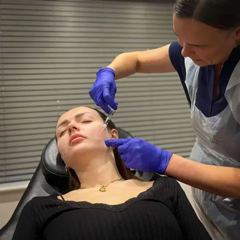 Abby undergoing facial injection